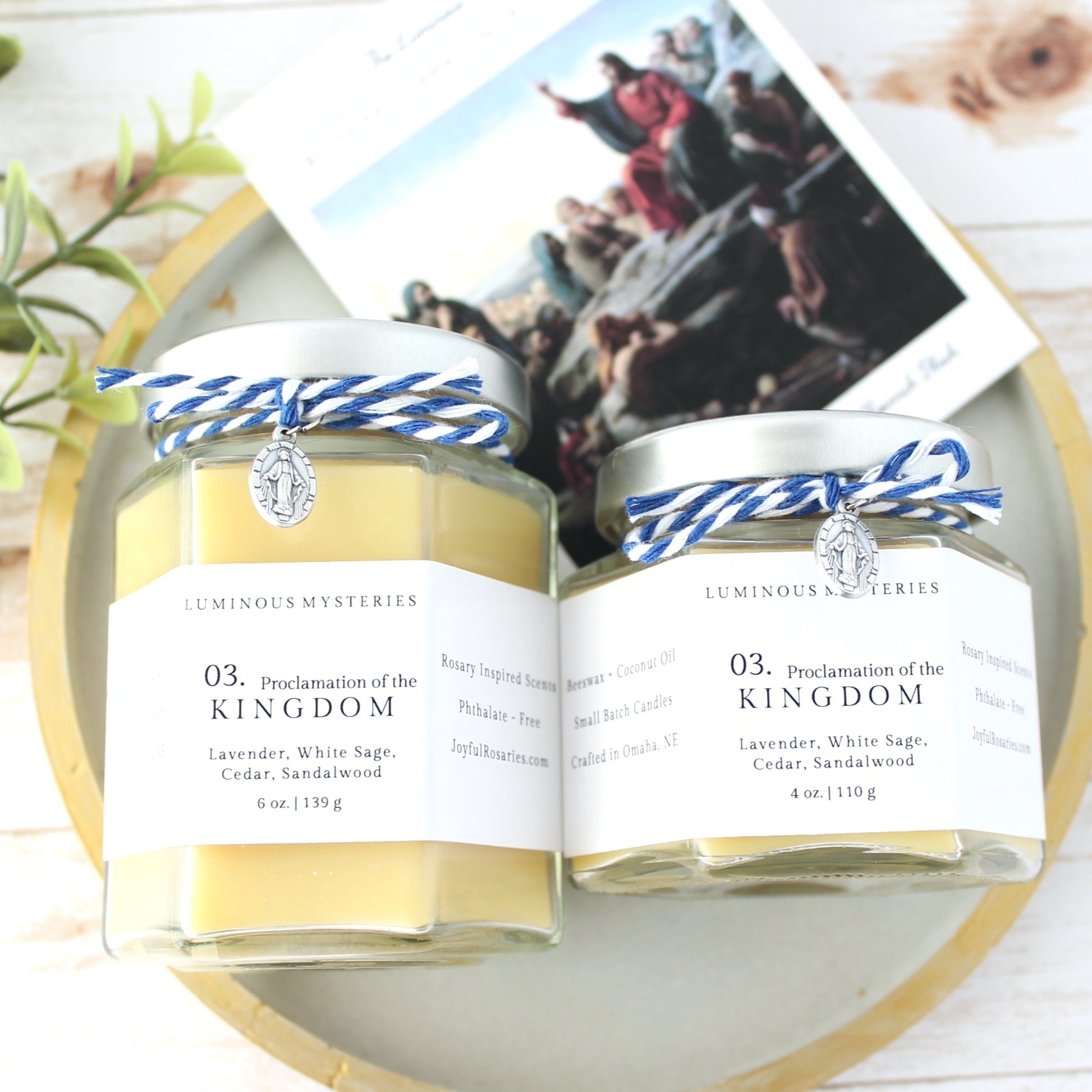 Two candles with blue and white labels on a wooden surface